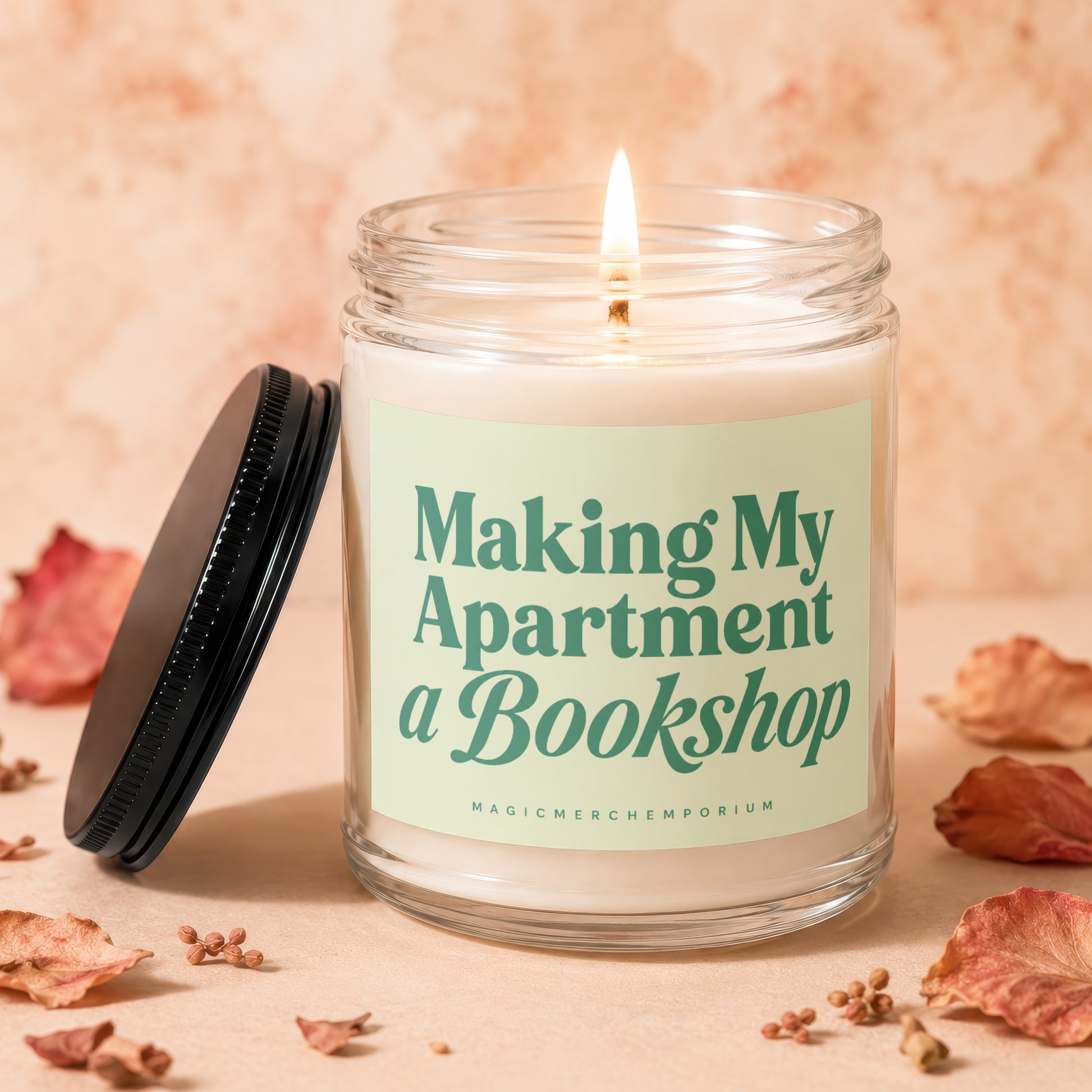 Lit candle in a glass jar with a light green label that reads "Making My Apartment a Bookshop".