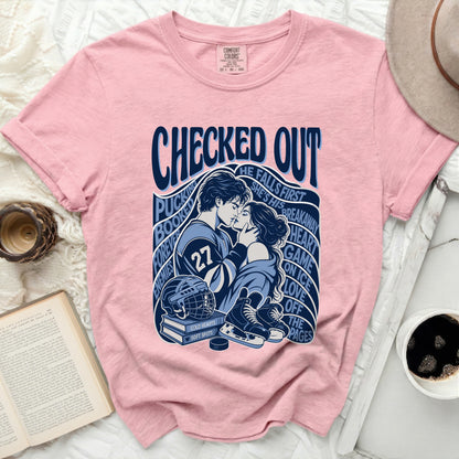 Pink t-shirt with a graphic of a couple kissing with hockey elements and text.