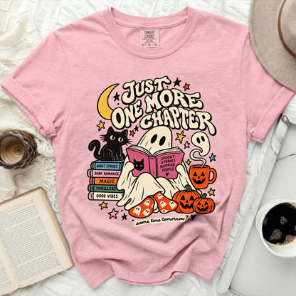 Pink t-shirt with ghost reading "Spooky Stories Happier People" and text "Just one more chapter".