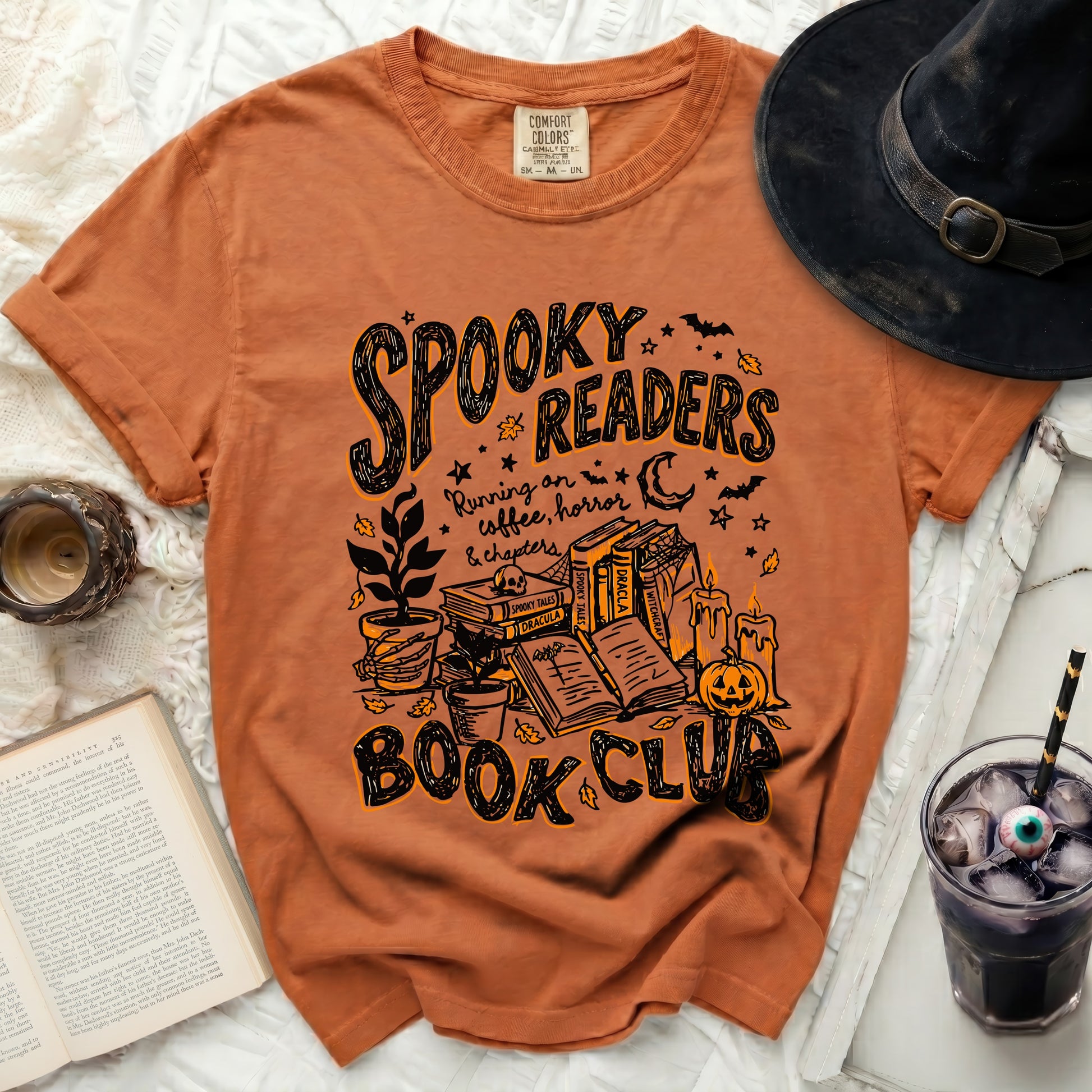 Orange t-shirt with spooky Halloween graphic reading "Spooky Readers Book Club."