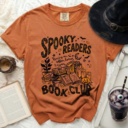 Orange t-shirt with spooky Halloween graphic reading "Spooky Readers Book Club."