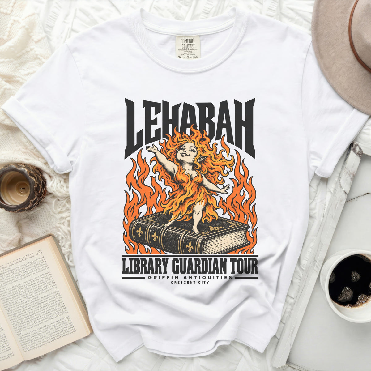 White t-shirt with "LEHABAH LIBRARY GUARDIAN TOUR" graphic and fiery creature.