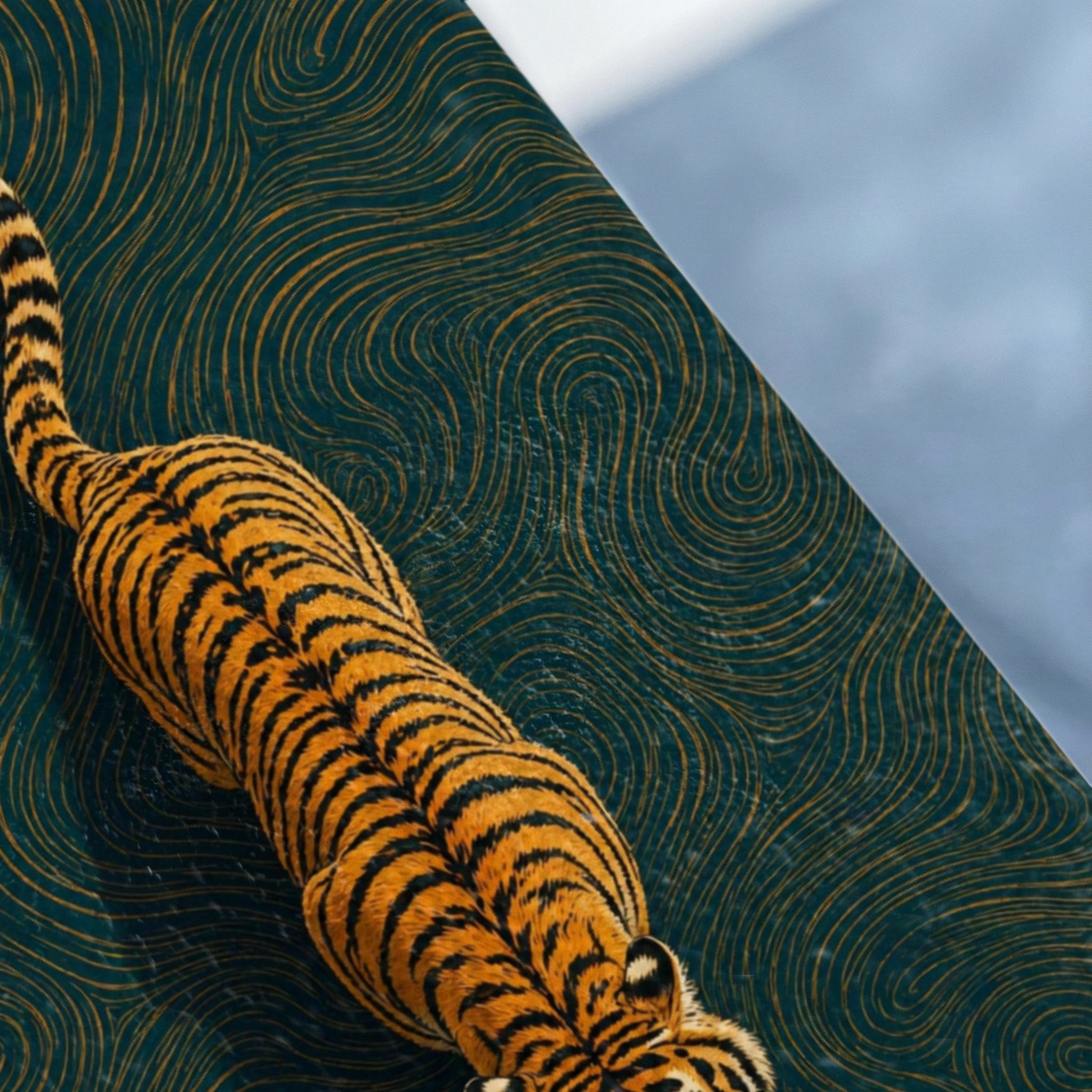 Tiger crawling across a dark teal surface with swirling gold patterns.