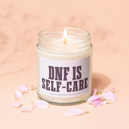 Jar candle with lit flame and "DNF IS SELF-CARE" text on label.
