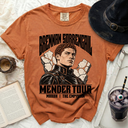 Orange t-shirt with "Brennan Sorrengal Mender Tour" graphic featuring a man and rocks.