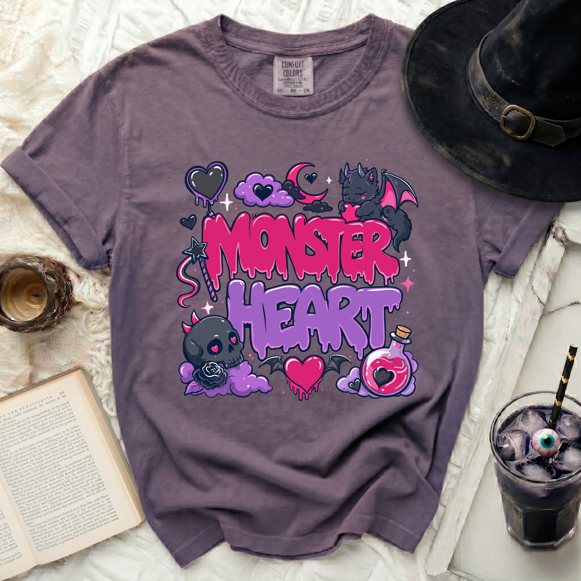 Purple t-shirt with "Monster Heart" graphic featuring hearts, clouds, and a bat.