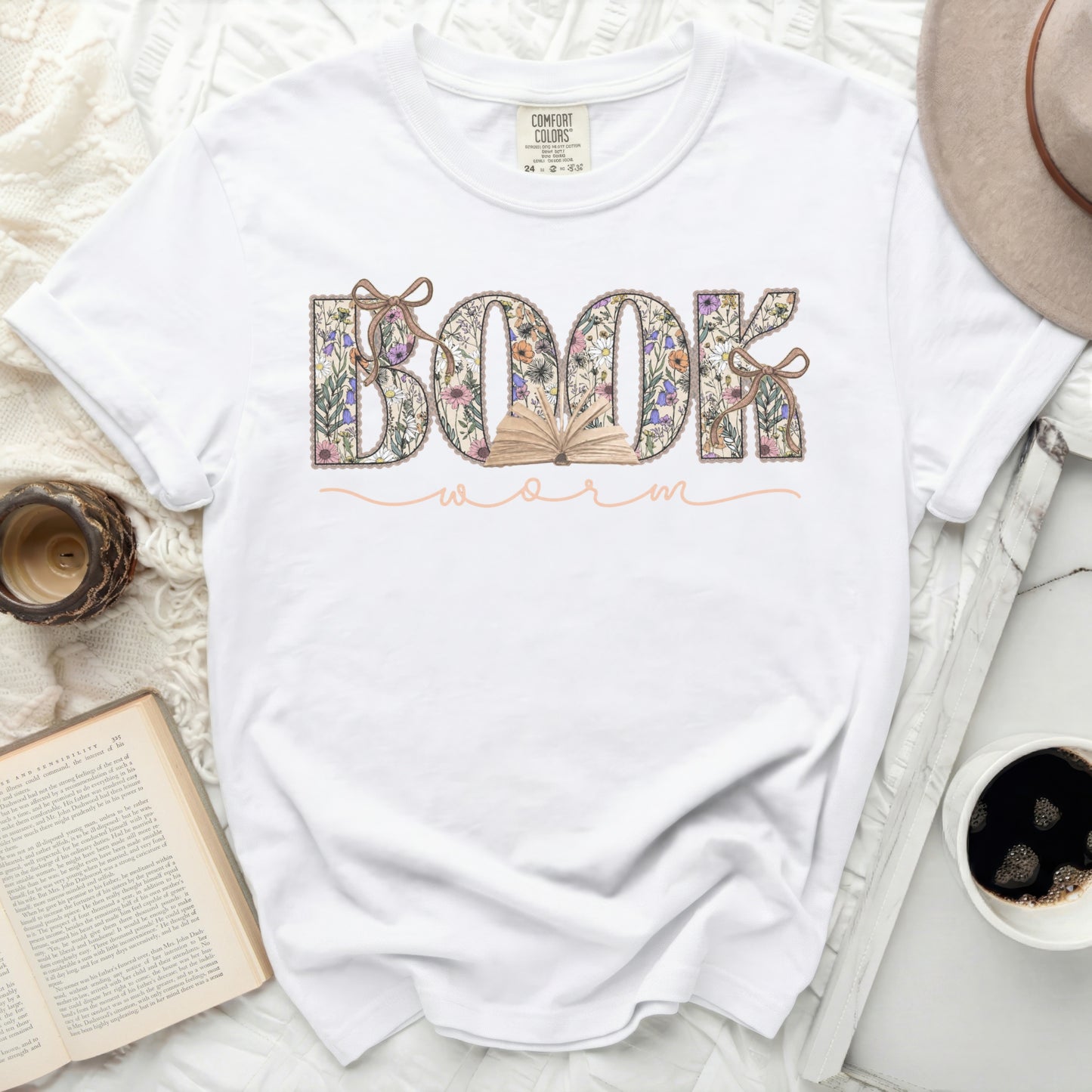 White t-shirt with "BOOKWORM" text in floral lettering.
