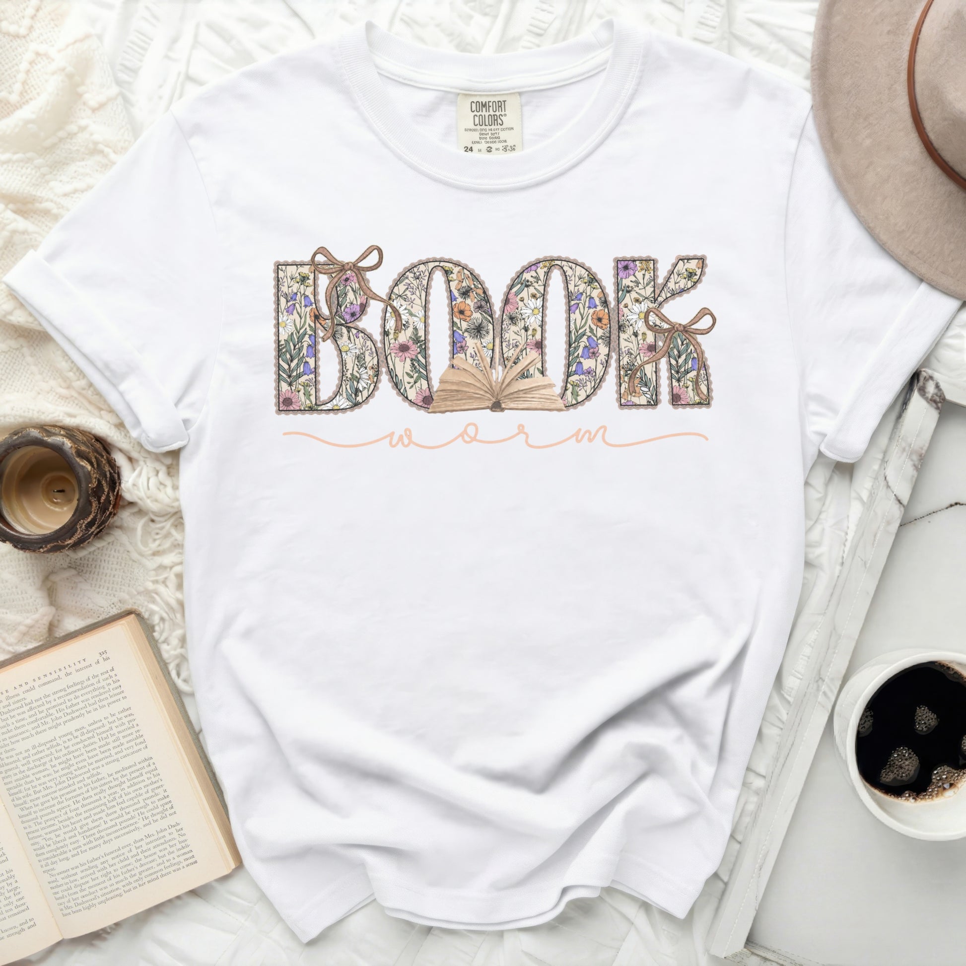 White t-shirt with "BOOKWORM" text in floral lettering.