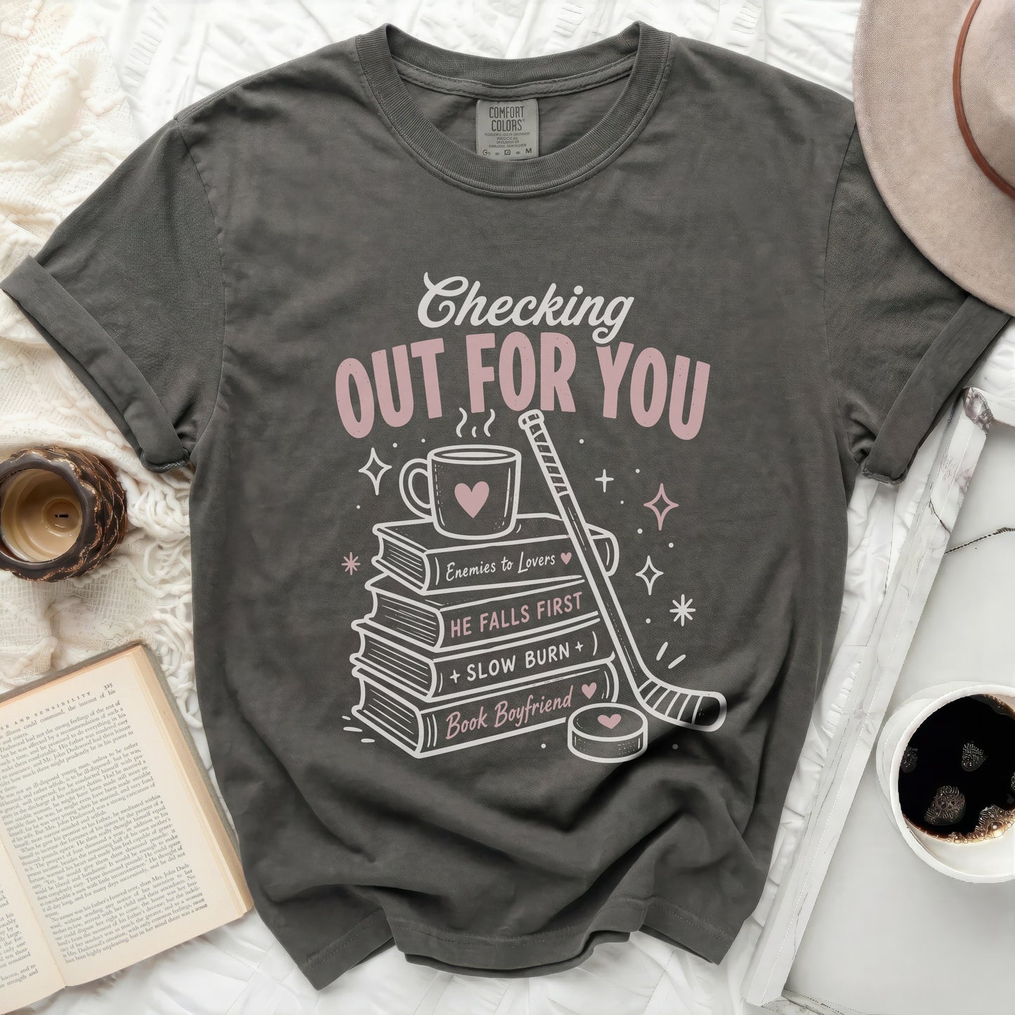 T-shirt with "Checking Out For You" and book-themed graphics.