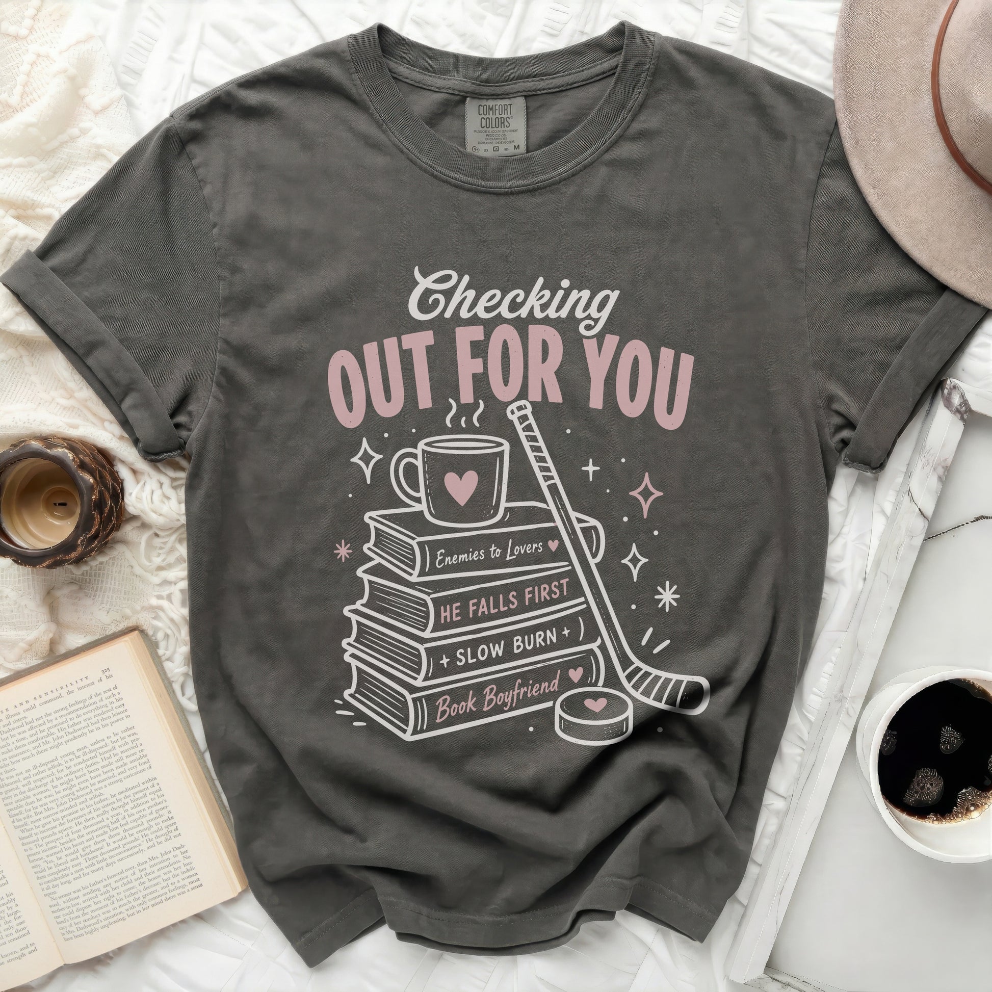 T-shirt with "Checking Out For You" and book-themed graphics.