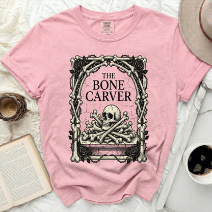 Pink t-shirt with "The Bone Carver" graphic featuring a skull and crossbones.