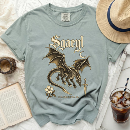 Pale blue t-shirt with a dragon, sword, flower, and text: "Sgaeyl DAGGERTAIL".