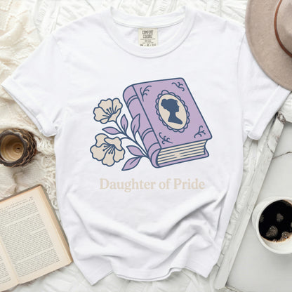 White t-shirt with purple book illustration and "Daughter of Pride" text.
