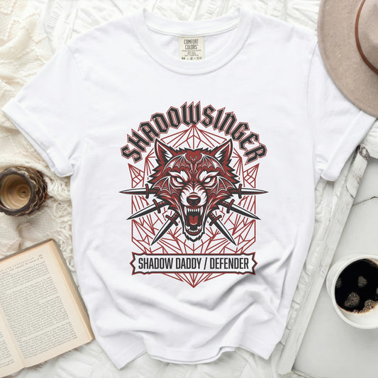 White t-shirt with a red wolf head graphic and text "Shadowsinger" and "Shadow Daddy / Defender".