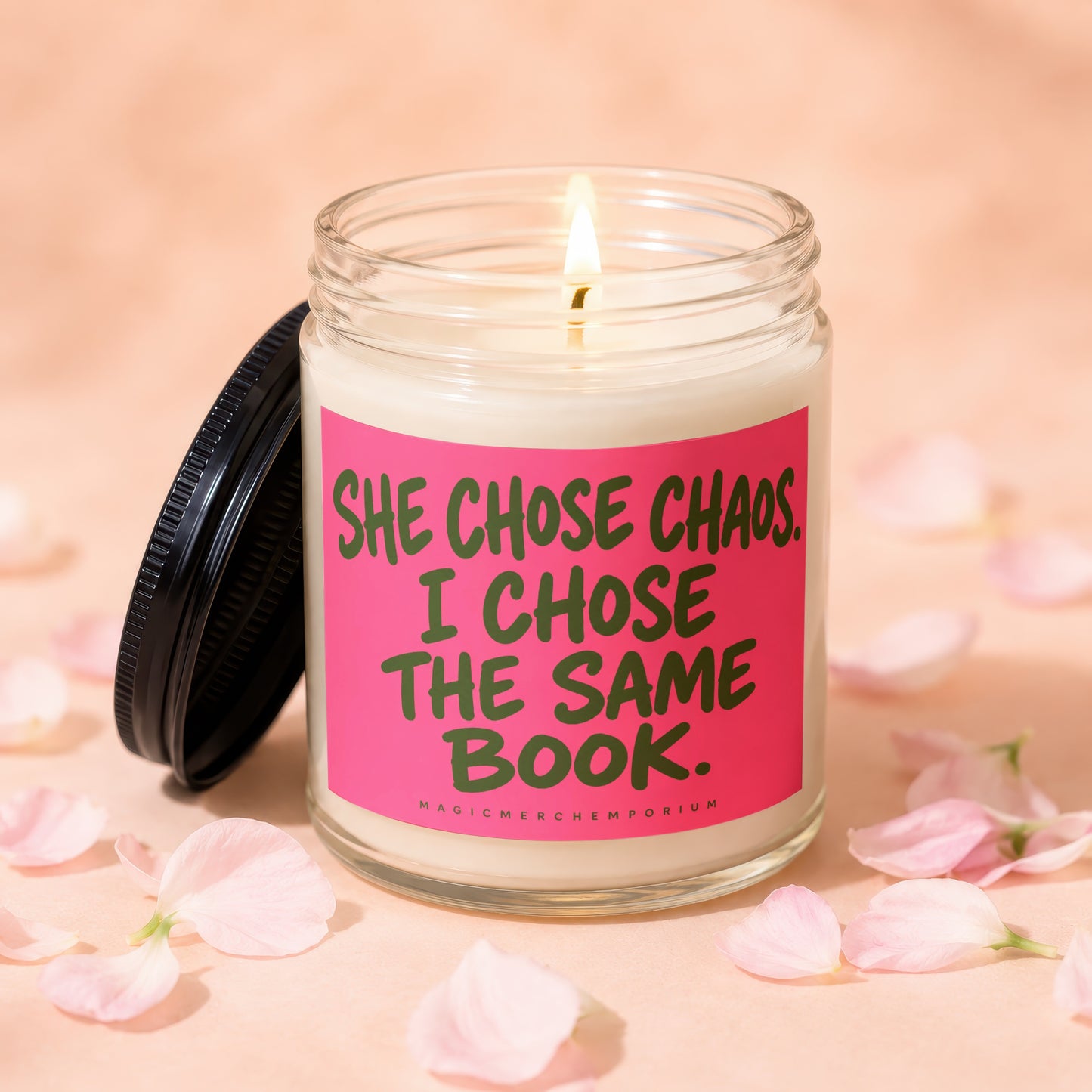Lit candle with lid off, phrase "SHE CHOSE CHAOS. I CHOSE THE SAME BOOK."