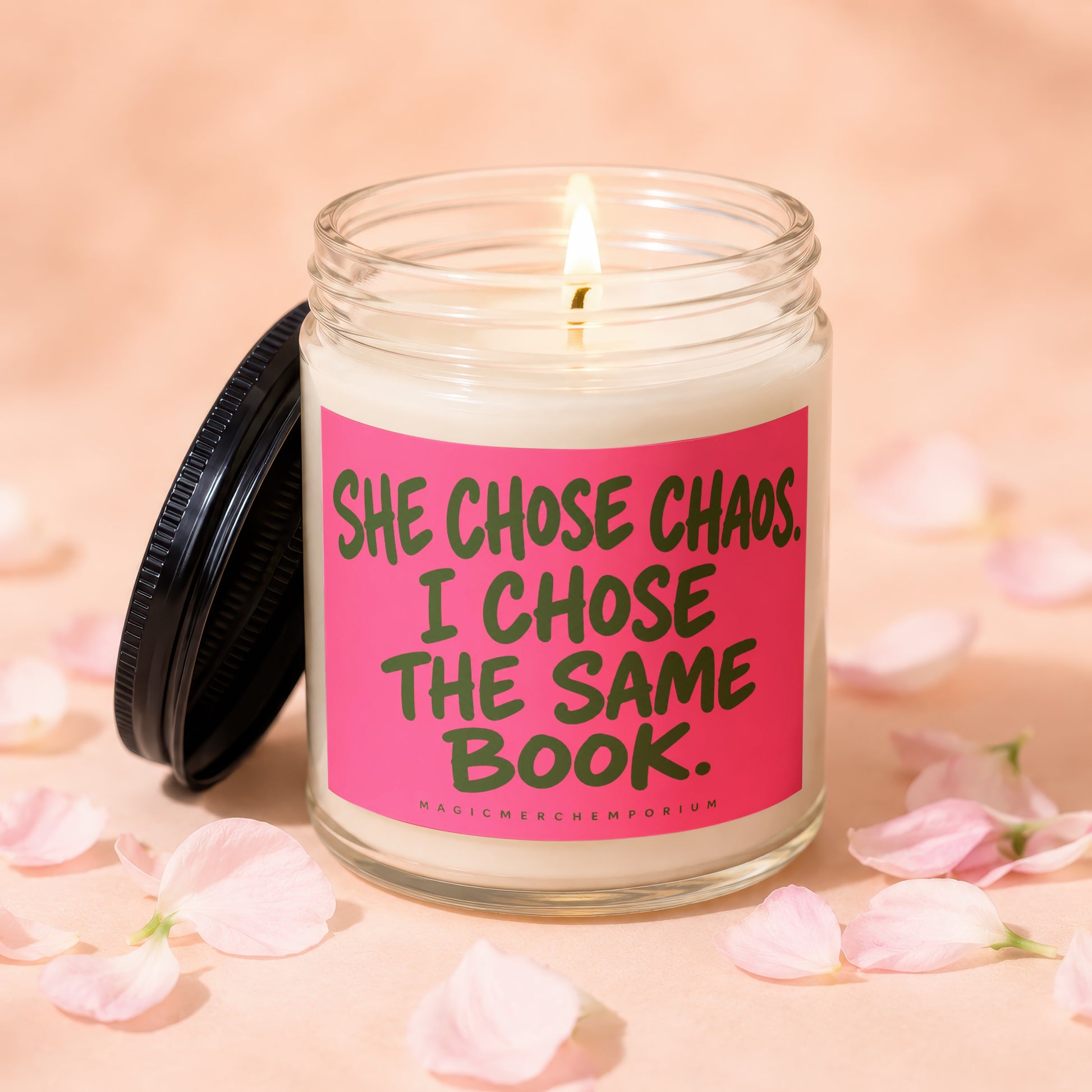 Lit candle with lid off, phrase "SHE CHOSE CHAOS. I CHOSE THE SAME BOOK."