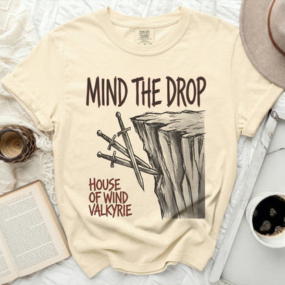 Cream t-shirt with "Mind the Drop House of Wind Valkyrie" text and sword graphic.
