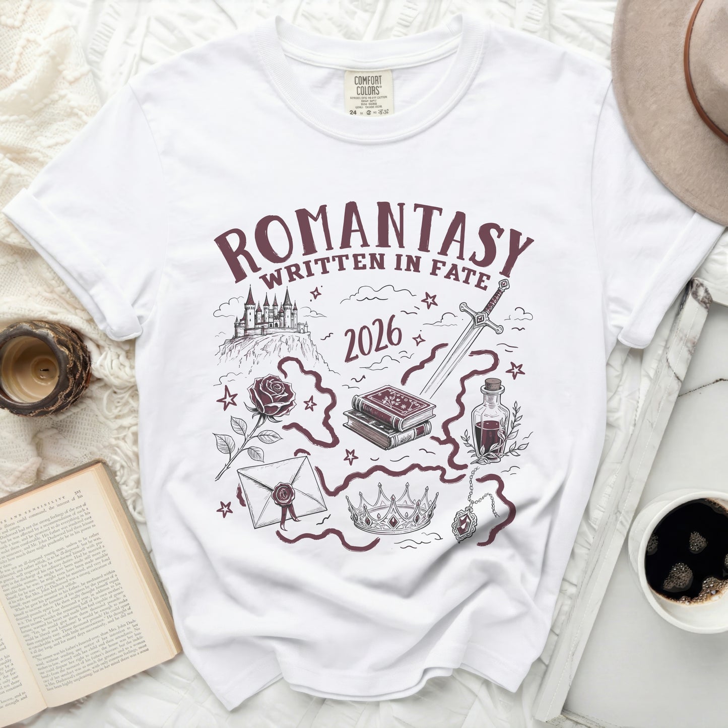 White t-shirt with "Romantasy Written in Fate 2026" graphic.