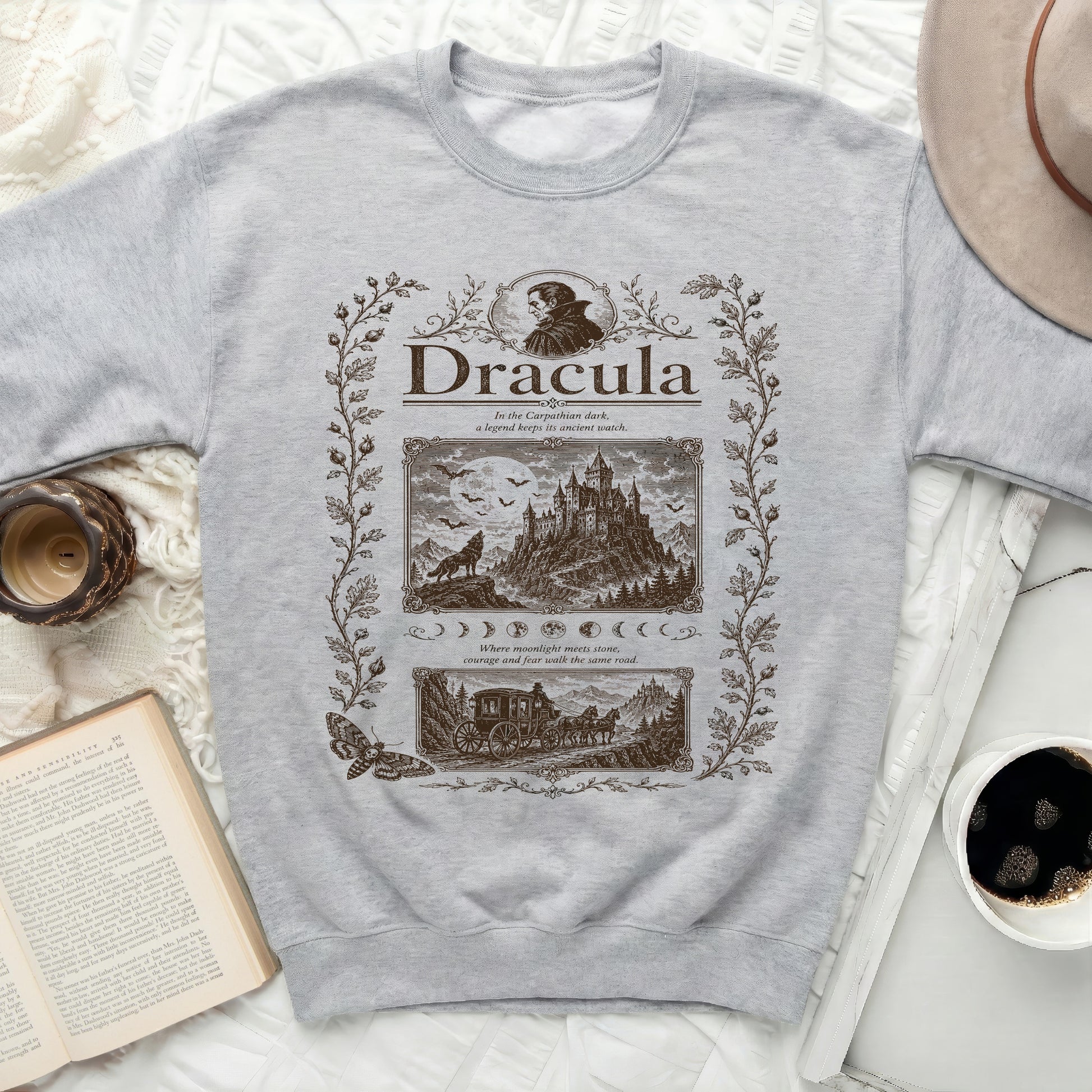 Grey sweatshirt with brown "Dracula" illustration and Romanian castle scene.
