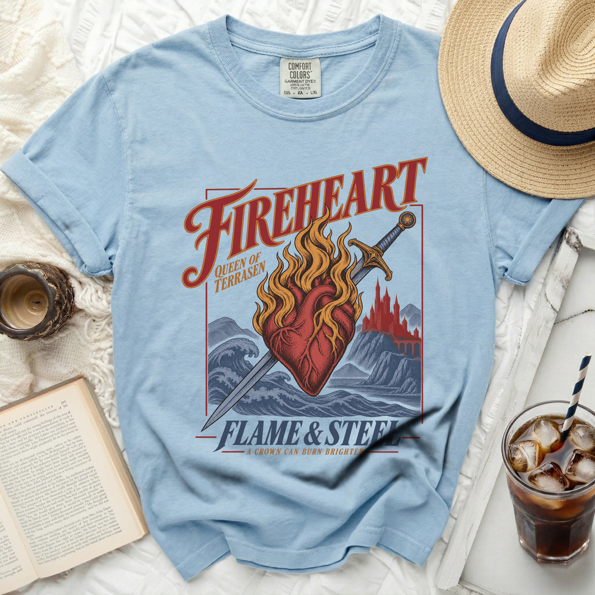 Light blue t-shirt with "Fireheart" graphic, heart, sword, and text.