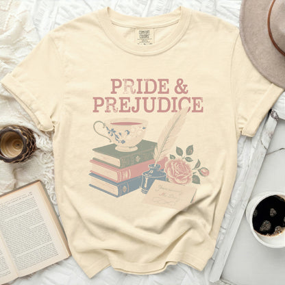 Cream t-shirt with Pride and Prejudice title, teacup, books, quill, ink, and rose.