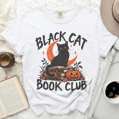 White t-shirt with black cat on books, pumpkin, and text "BLACK CAT BOOK CLUB".