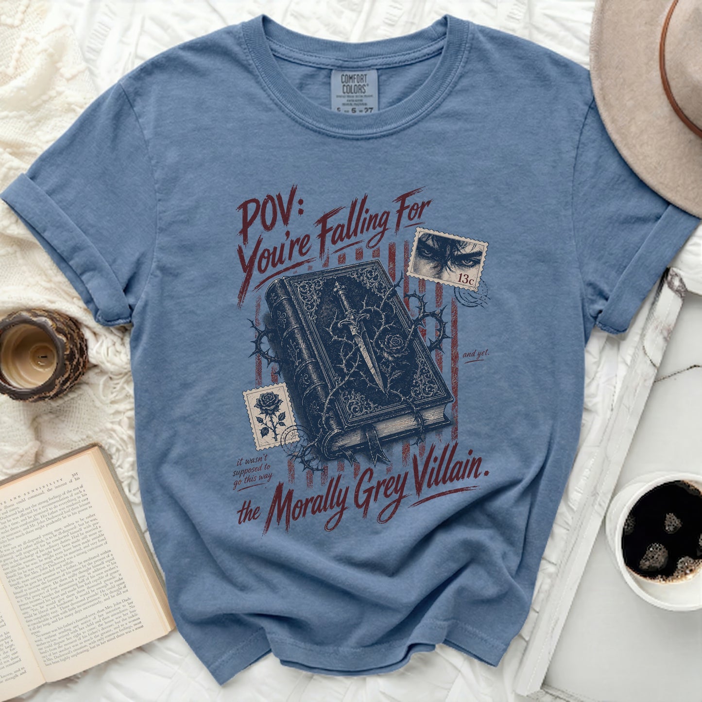 Blue t-shirt with "POV: You're Falling For the Morally Grey Villain." text.