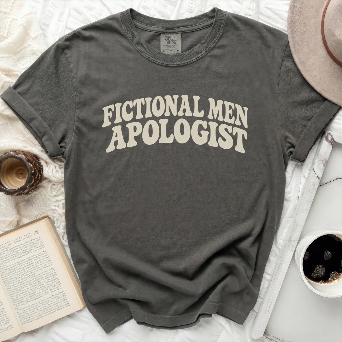 Comfort Colors t-shirt with "Fictional Men Apologist" text in cream.
