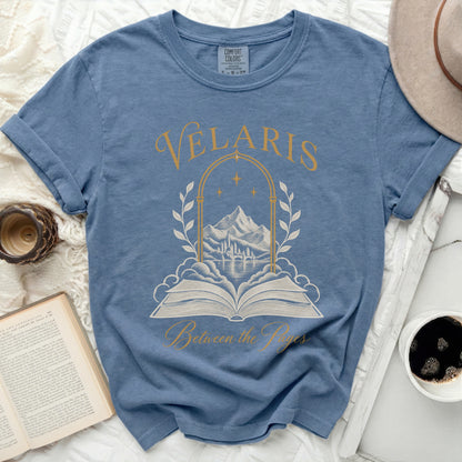 Blue t-shirt with gold text and design of an open book and castle.