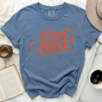 Blue t-shirt with "Plot Twist!" in orange cursive text.