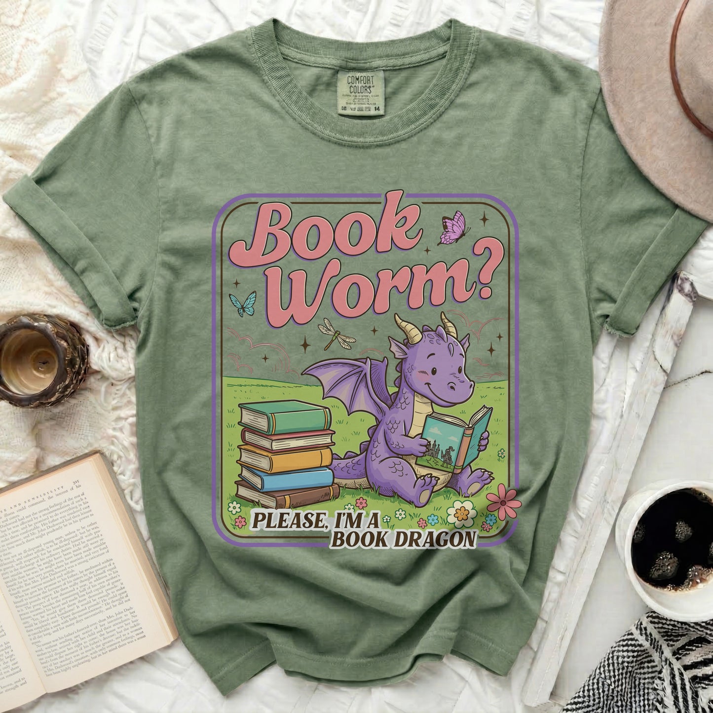 Green t-shirt with a cartoon dragon reading books, "Book Worm?" and "PLEASE, I'M A BOOK DRAGON" text.