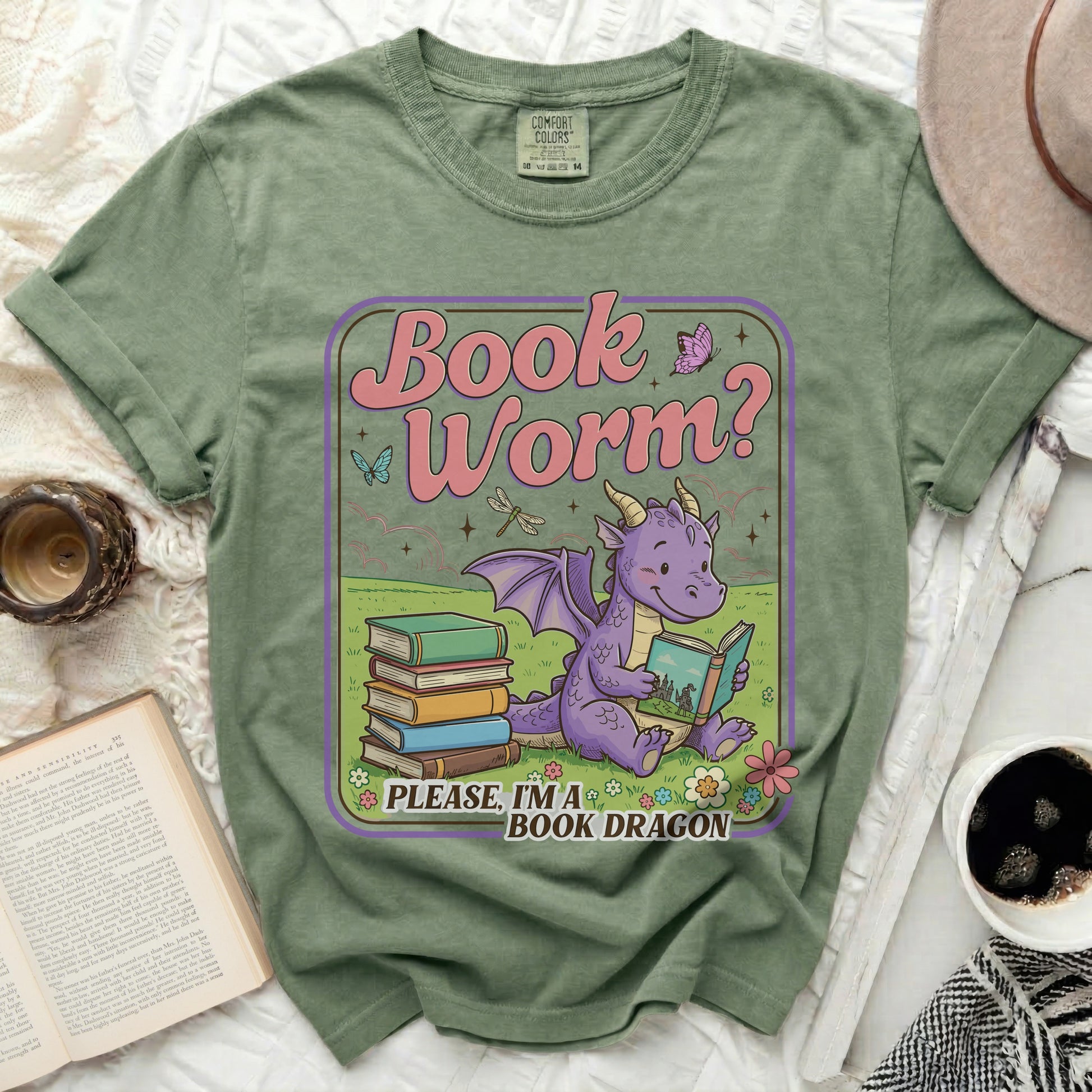 Green t-shirt with a cartoon dragon reading books, "Book Worm?" and "PLEASE, I'M A BOOK DRAGON" text.