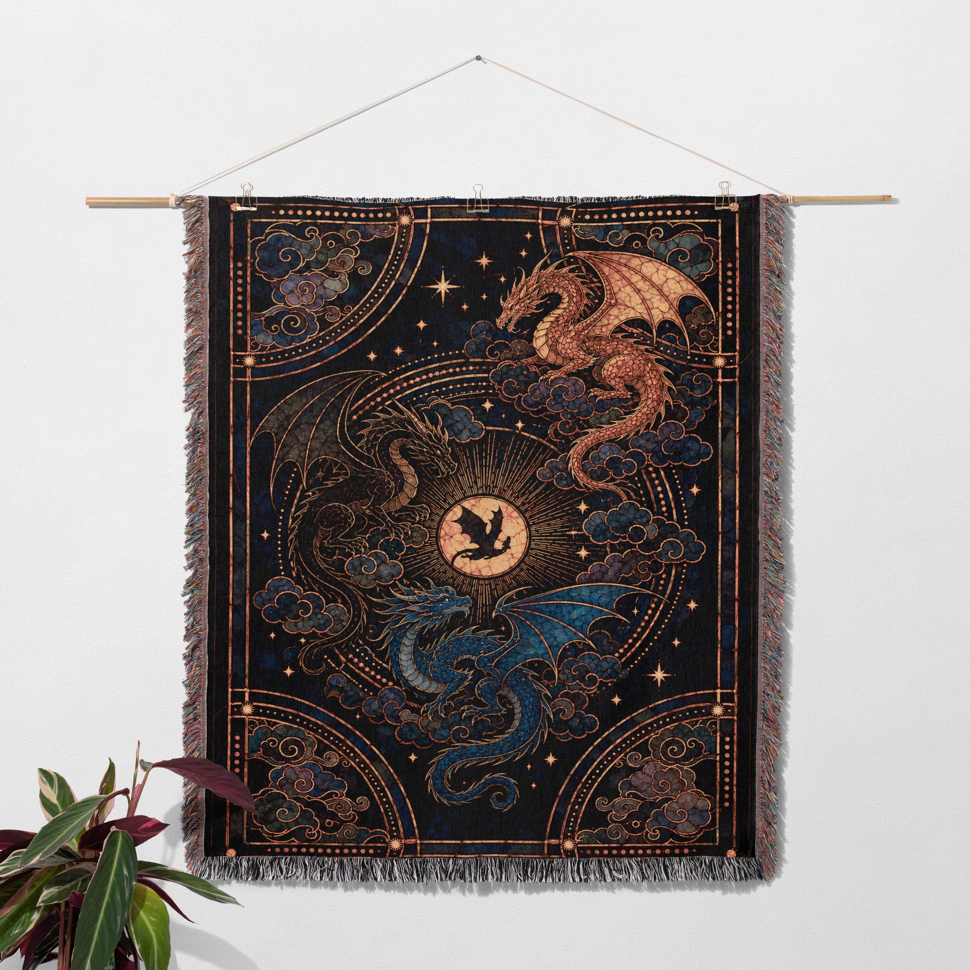 a large tapestry hanging on a wall, depicting a dragon and a sun.
