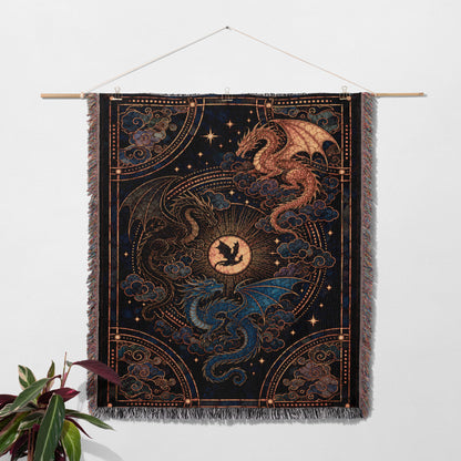 a large tapestry hanging on a wall, depicting a dragon and a sun.