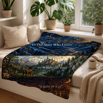 Blanket featuring stained glass art of stars, mountains, castle, deer, and city with quotes.