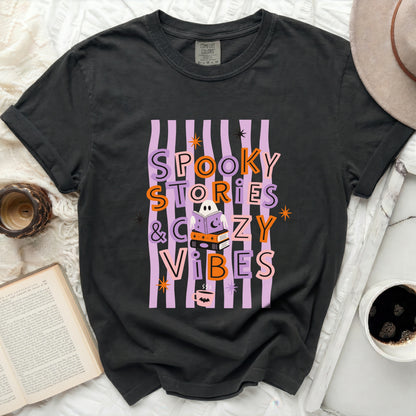 Gray t-shirt with "Spooky Stories & Cozy Vibes" Halloween graphic.