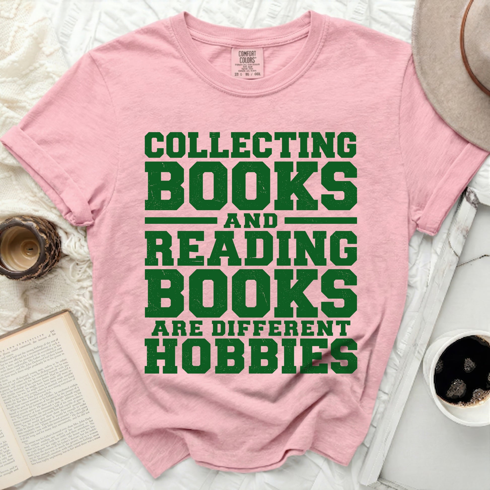 Pink t-shirt with green text "Collecting Books And Reading Books Are Different Hobbies".