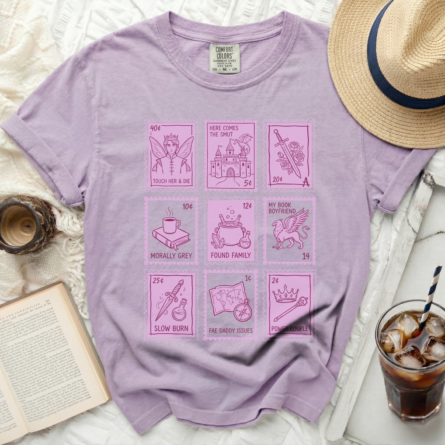 Purple t-shirt with "Here Comes the Smut" and literary tropes in postage stamp designs.