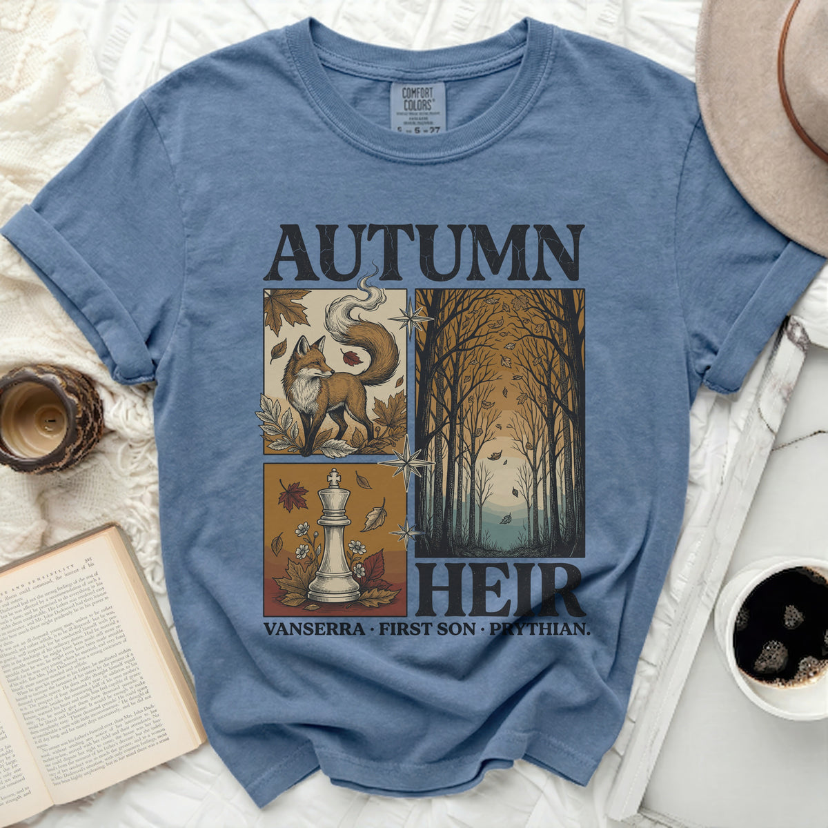 Blue t-shirt with "Autumn Heir" design featuring a fox, chess piece, and forest scene.