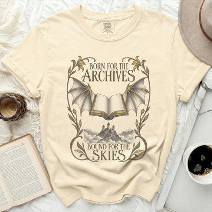 T-shirt with "Born for the Archives, Bound for the Skies" text and book with wings.