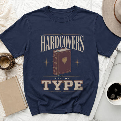 Navy t-shirt with "HARDCOVERS ARE MY TYPE" text and a vintage book graphic.