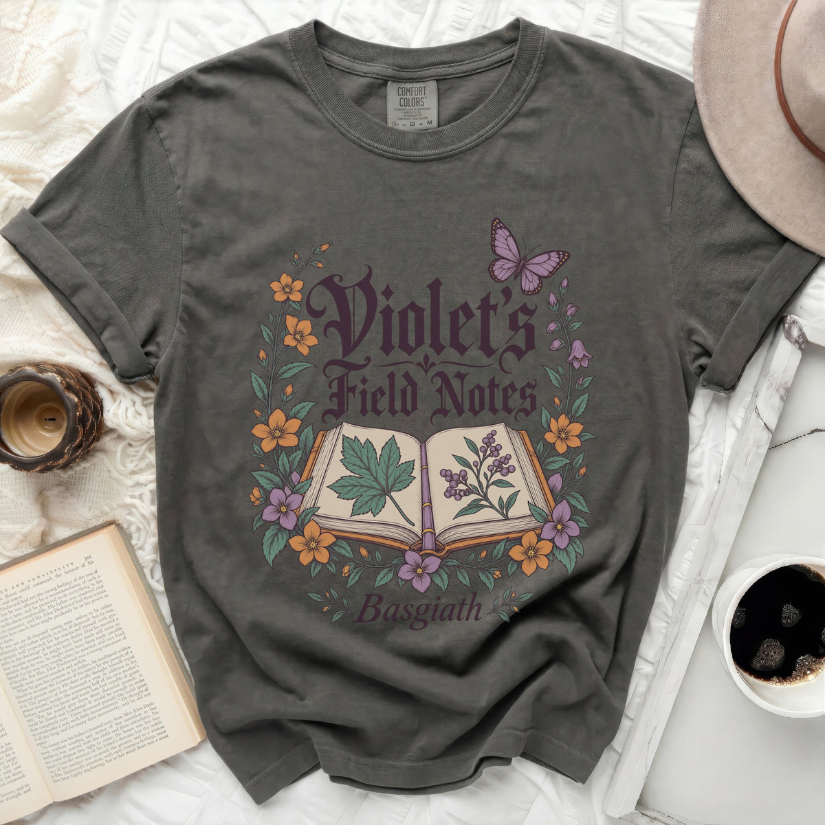 Gray t-shirt with "Violet's Field Notes Basgiath" text and botanical illustration.