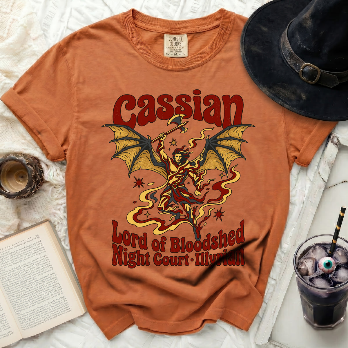 Orange t-shirt with "Cassian Lord of Bloodshed Night Court. Illlyrian" graphic.