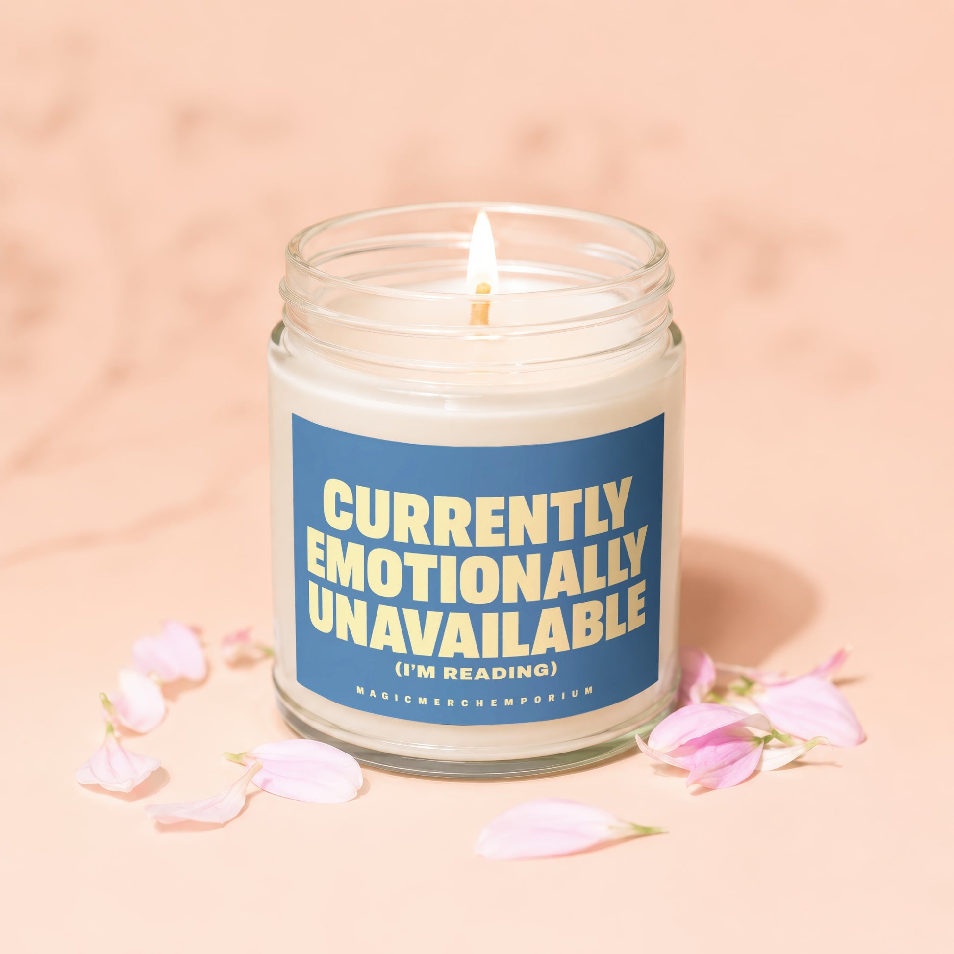 Jar candle labeled "Currently Emotionally Unavailable (I'm Reading)" with petals.