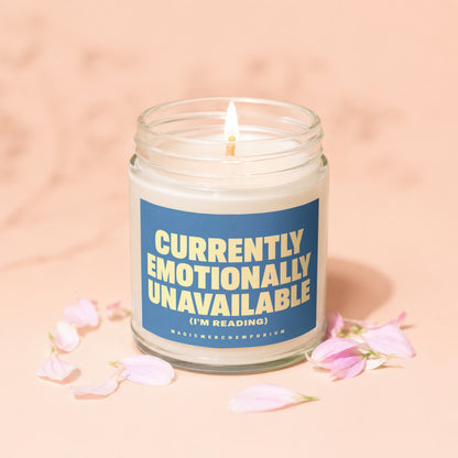 Jar candle labeled "Currently Emotionally Unavailable (I'm Reading)" with petals.