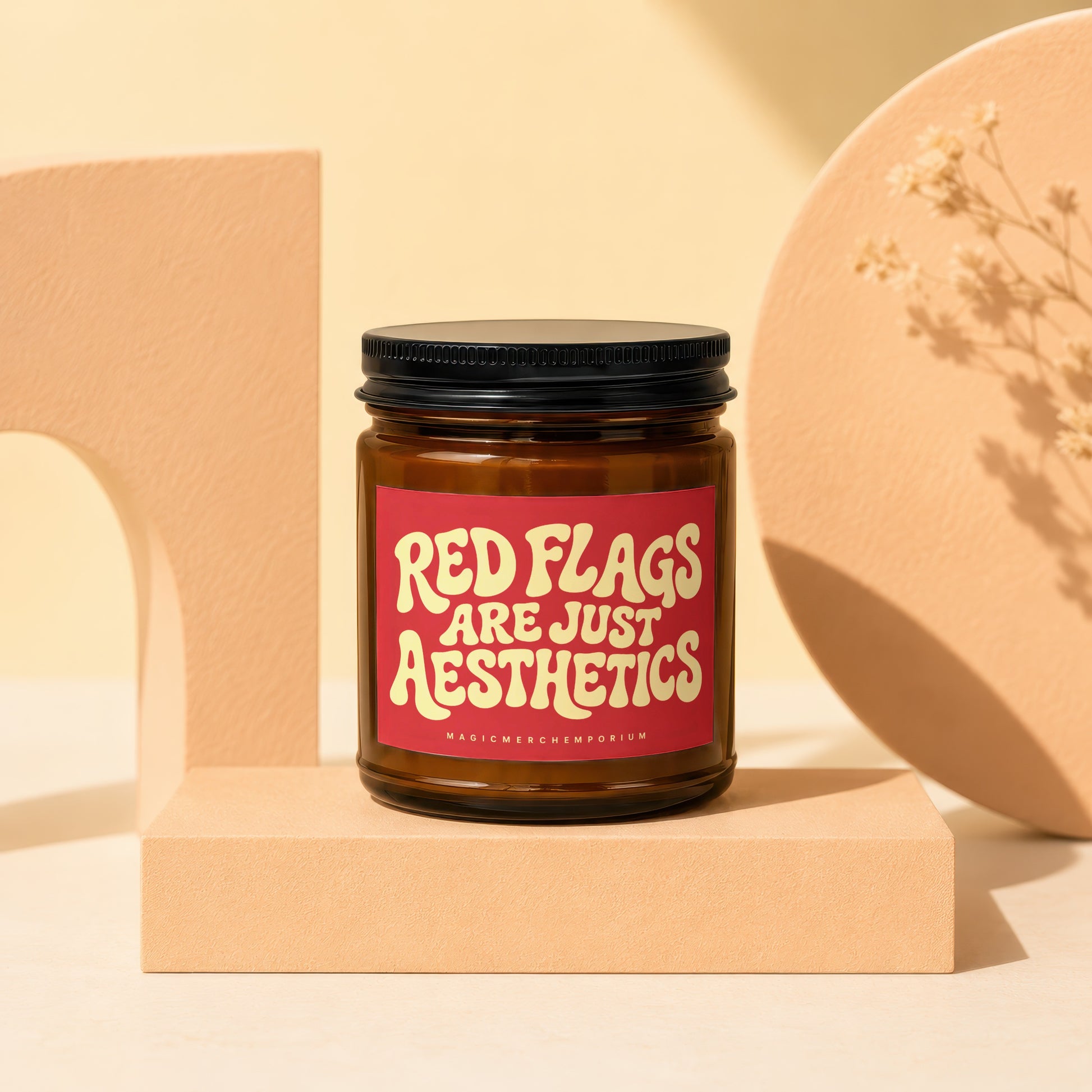 Amber jar candle with red label reading "RED FLAGS ARE JUST AESTHETICS".