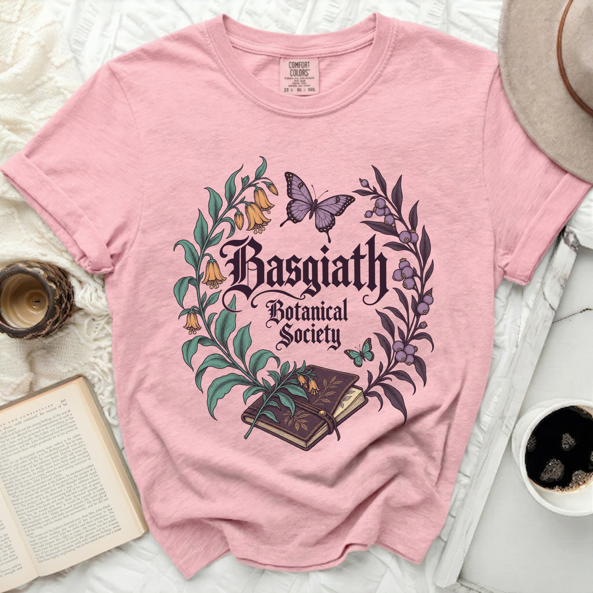 Pink t-shirt with "Basgiath Botanical Society" text and floral illustration.