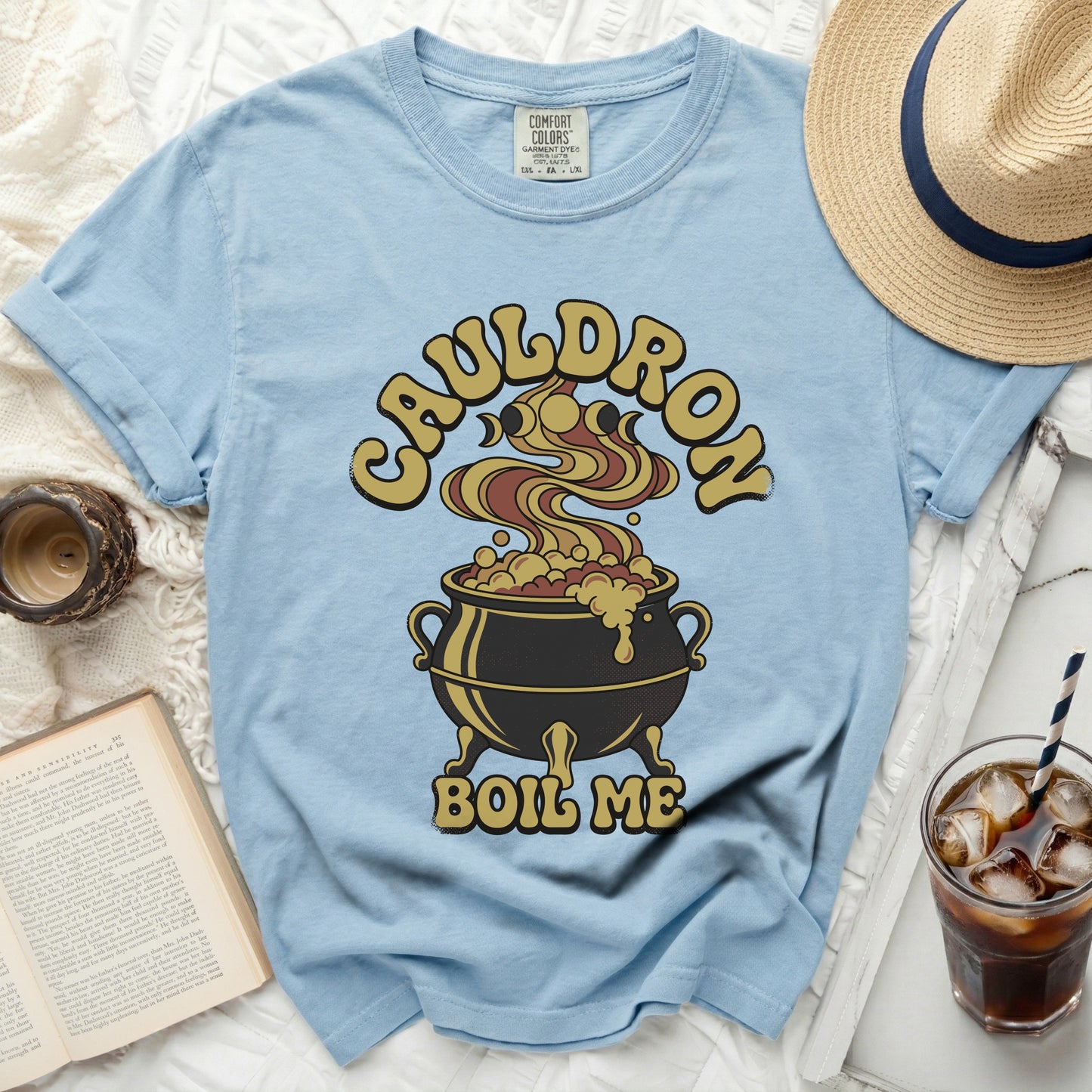 Light blue t-shirt with "Cauldron Boil Me" graphic of a cauldron.