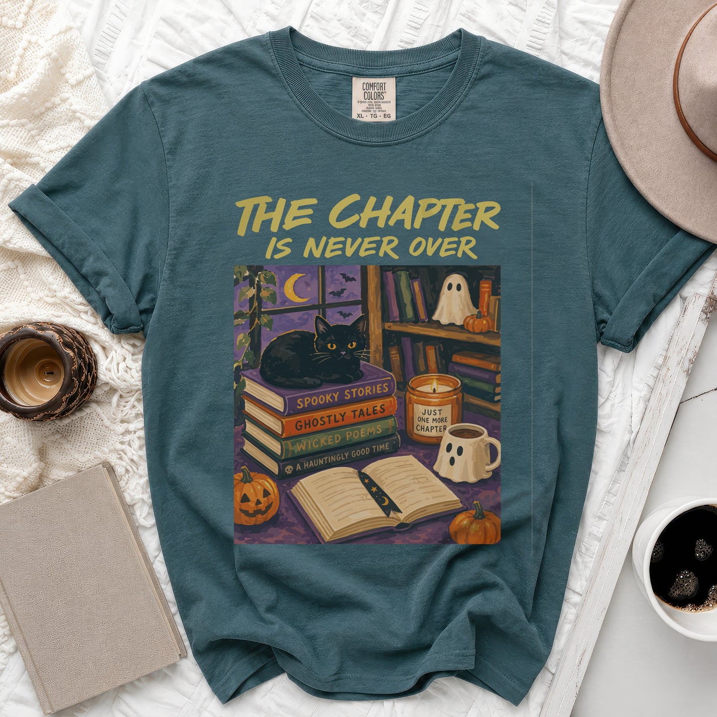 Teal t-shirt with "The Chapter Is Never Over" and Halloween scene.
