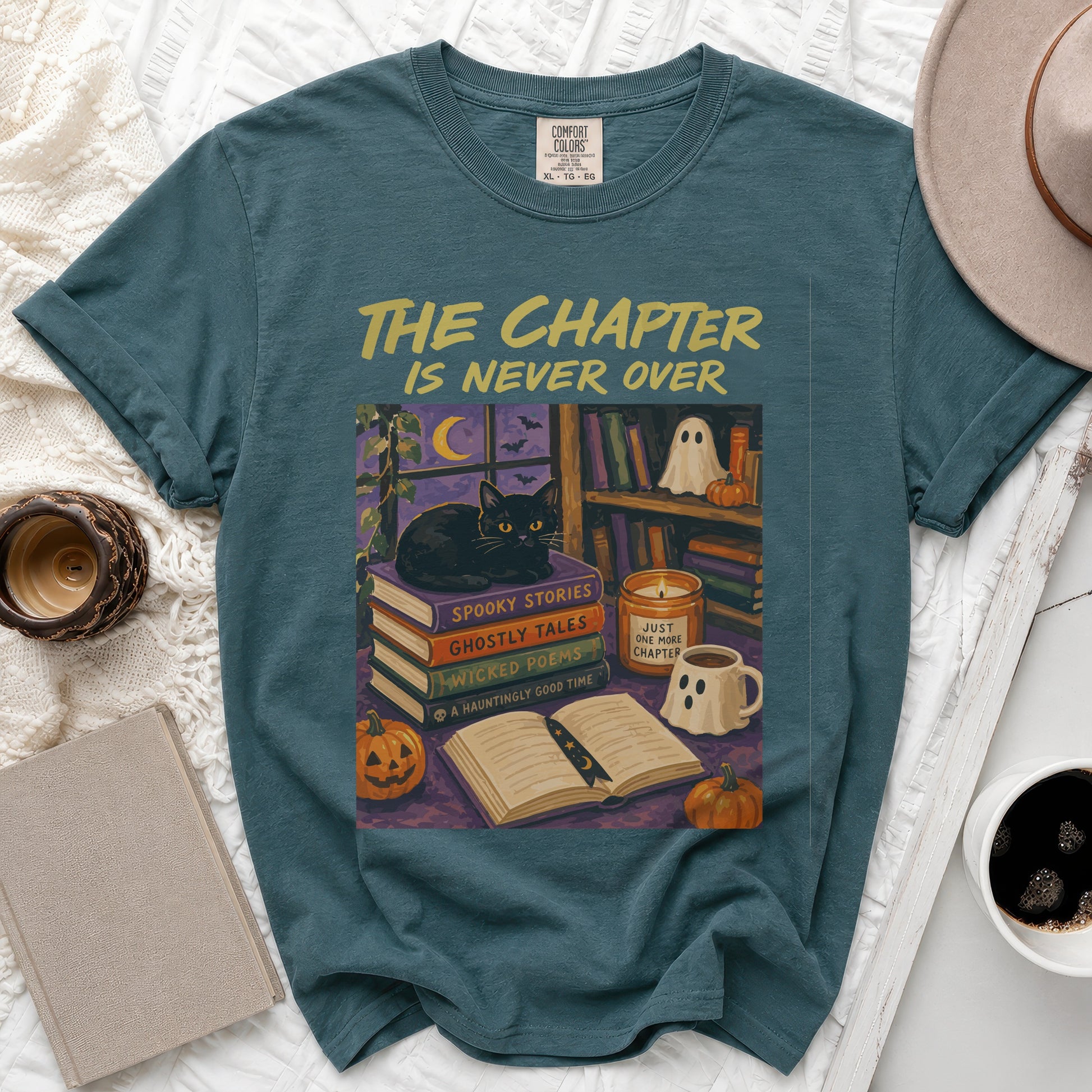 Teal t-shirt with "The Chapter Is Never Over" and Halloween scene.